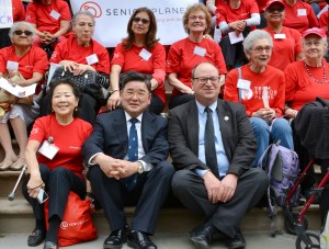 Council Members Peter Koo and Barry S. Grodenchik sat for a photo with the Senior Planet Campaigners.